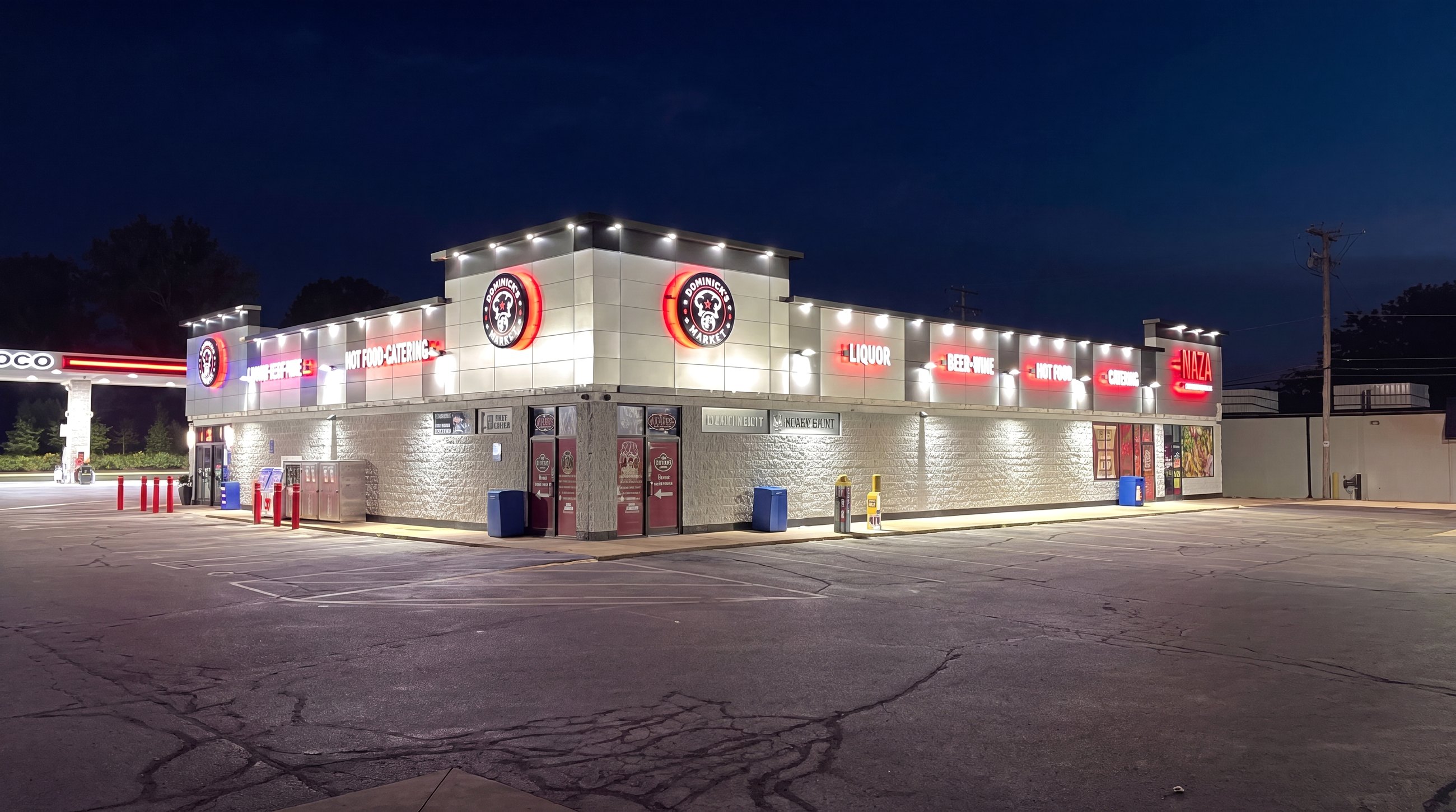 Dominick's Market storefront and fuel station lit up at night in Taylor, Michigan
